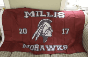 Millis mohawks flag laying on a couch