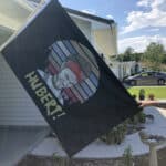 Hubert flag hanging up on a driveway flag pole