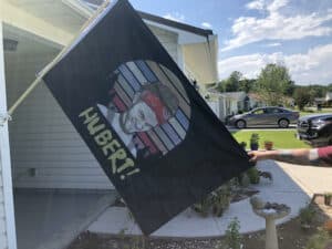 Hubert flag hanging up on a driveway flag pole